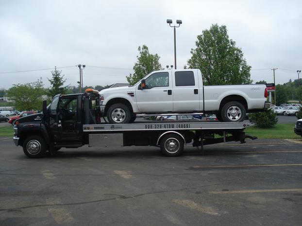 white pick up truck has been towed