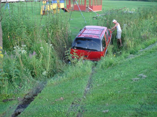 man checking his crashed car