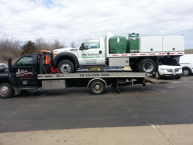 white pick-up getting towed