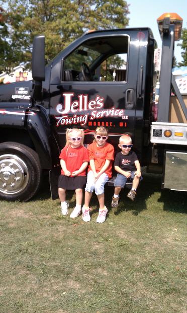 kids getting a picture of the towed truck